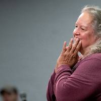 Robin Wall Kimmerer with her hands joined in front of her mouth as a gesture of gratitude